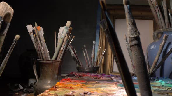 Art studio interior with tools for painting - Brushes, oil paints, palette, canvas, easel alt