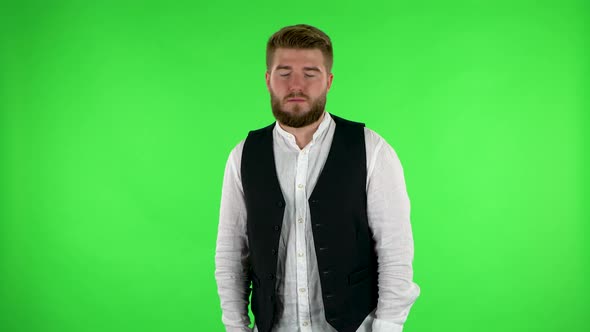 Man Stands Waiting with Boredom. Green Screen alt