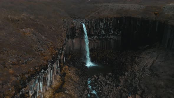 Aerial View of the Svartifoss Waterfall Surrounded By Basalt Columns in Iceland alt