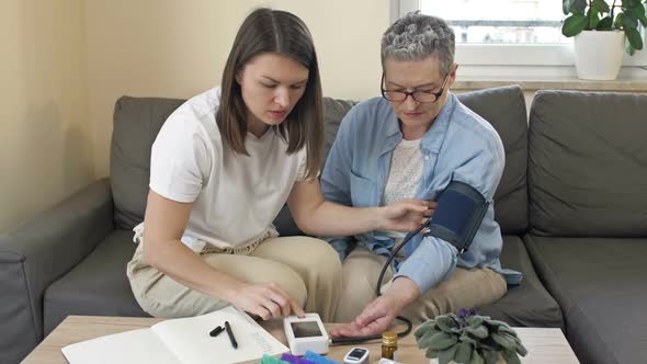 An Adult Daughter Measures the Pressure of a Mother alt