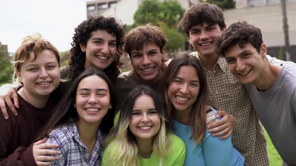 Happy diverse young people smiling on camera outside of university