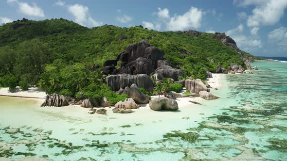 Aerial arc shot over a unique incomparable beach Anse Source d'Argent alt