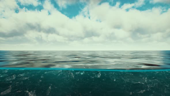Split View Over and Under Water in the Caribbean Sea with Clouds alt