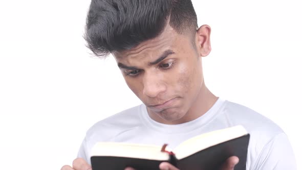 Close Up of Young Man Hand Reading a Book alt