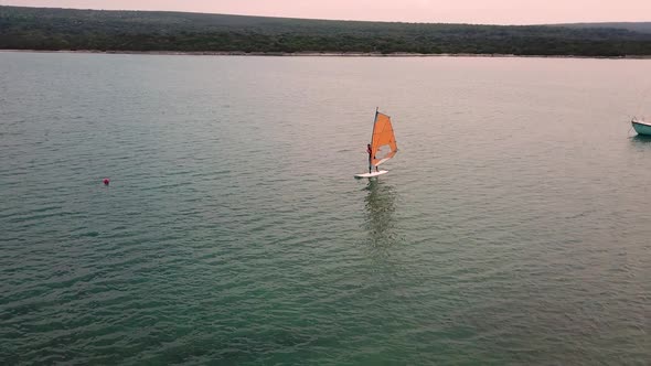 Aerial view of man practicing kitesurfing at transparent water, Croatia. alt