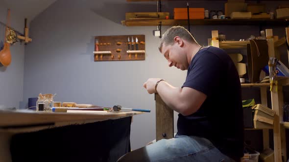 Tanner Sews a Needle Leather Product in the Studio. He Makes a Purse for Individual Design