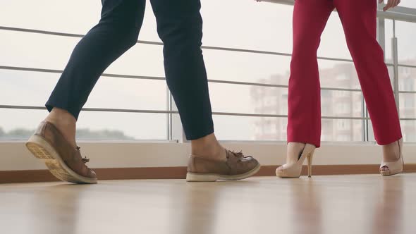 Legs of a Man and a Woman Approaching Each Other Indoors. Man and Woman Go To Meet Each Other. alt
