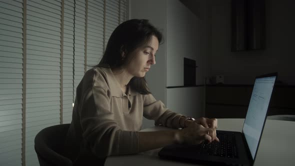 Female Freelancer Using Laptop Late At Night