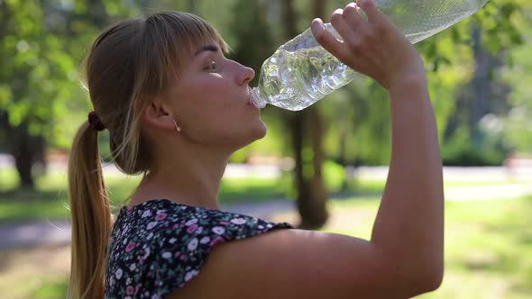 Woman Drink Water in the Park