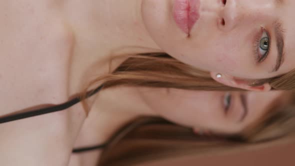 Vertical Close Up of Faces of Twin Sisters alt