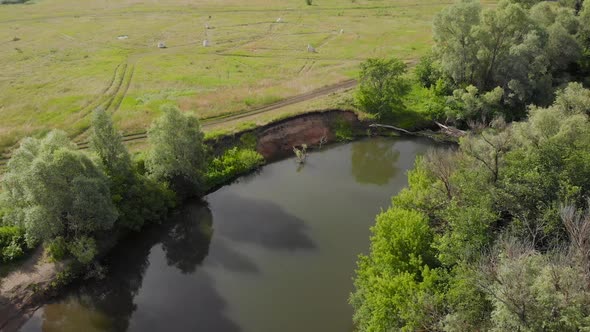 An Aerial View. Beautiful Summer Landscape in the Middle Strip of Russia. Along the Narrow, Winding alt