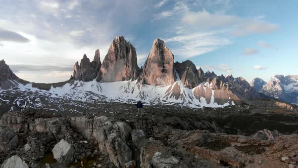 Aerial Man Hiker In Front of Tre Cime di Lavaredo Mountain in Dolomites Italy