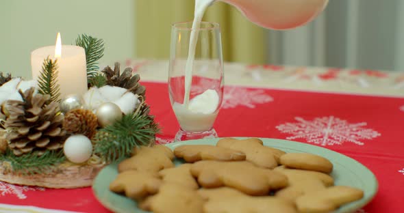 Traditional Christmas Gingerbread Cookies with Ginger on a Wooden Stand. In a Glass Cup, Milk alt