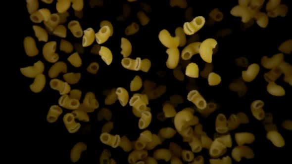 Pasta Pipe Flies Up on Black Background alt