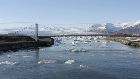 Flight Along the River Leading to Glacier Lagoon and Under the Bridge alt