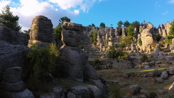 Aerial View of Valley with Picturesque Rock Formations on a Summer Day alt