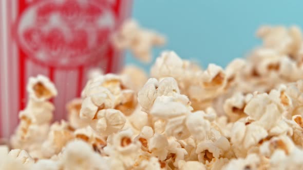 Falling Popcorn in Super Slow Motion on Blue Background. alt