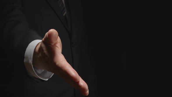 Businessman gives handshake (half-side)