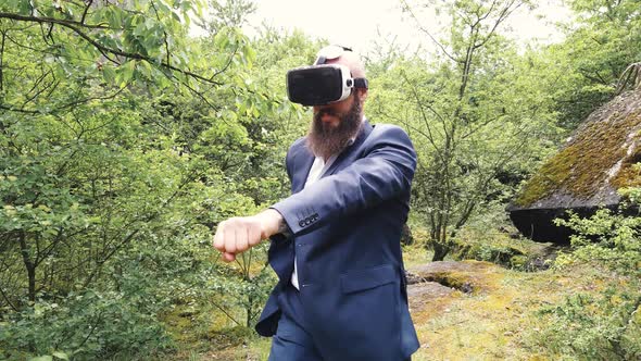 Businessman doing box training wearing virtual reality goggles
