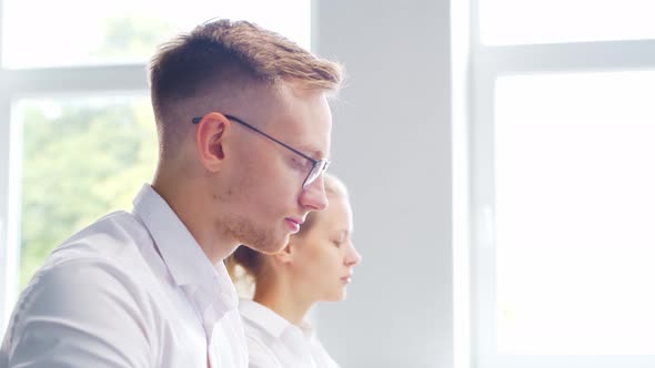 Diverse team of young professionals is working in the e-mail support center. alt