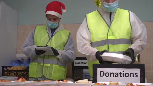 Happy group of volunteers at food bank. Food pantry and public meal program alt