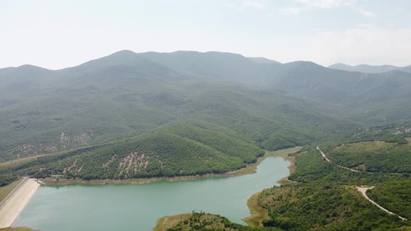 Mountains in Greenery and a Lake View From the Air alt