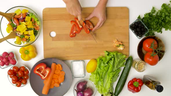 Young Woman Chopping Pepper for Salad at Home alt