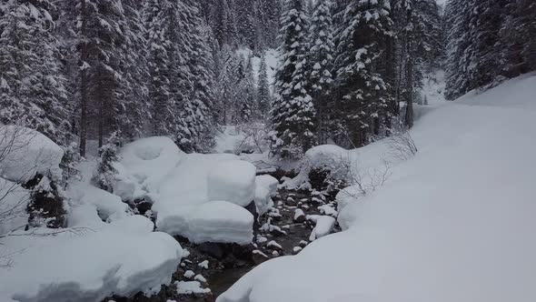 winter wonderland in the alps. A small valley with a snowy creek, Kleinwalsertal, Austria alt