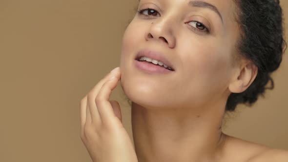 Beauty Portrait of Young African American Woman She Gently Touches Face with Her Fingers alt