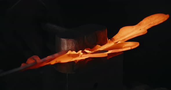 Blacksmith Makes a Grooved Surface for Decorative Redhot Forged Metal Product with Hydraulic Hammer alt