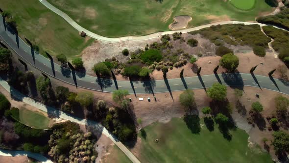 Drone flies over road in vivid landscape, United States. Aerial top down shot of highway, Orange Cou alt