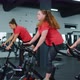 Healthy Caucasian Group of Women Exercising Workout on Stationary Cycling Machine Bike in Gym - VideoHive Item for Sale