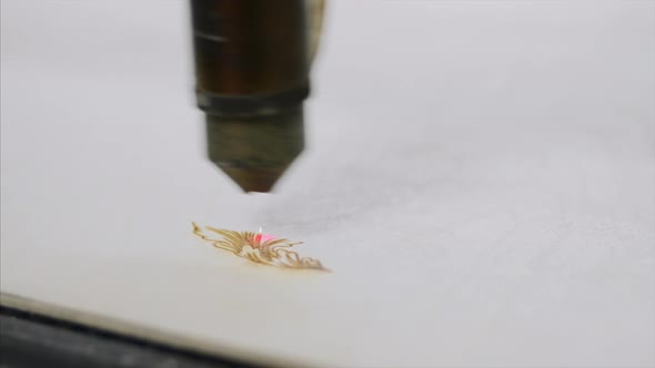 Industrial Laser is Engraving a Pattern on a Plywood Sheet