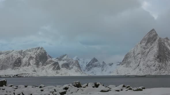 Fjord Surrounded by Winter Mountains and Clouds