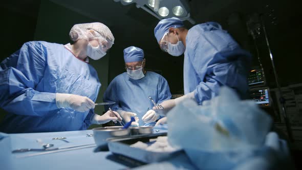 Surgical Doctors Operating on Patient alt