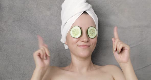 Portrait of a Young Beautiful Positive Funny Charming Woman with a Towel on Her Head and Slices of