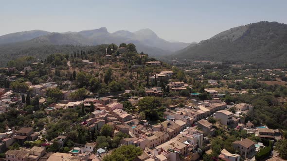 AERIAL: Overview shot of beautiful village on the hills in mallorca alt