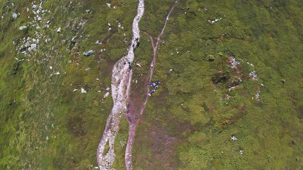 Aerial View of Group People Hiking Along Trail Path