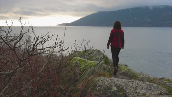Adventurous Girl Looking at the Beautiful Scenery on the West Pacific Ocean Coast alt