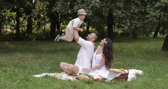 Father and Mother Reaching for Their Male Child