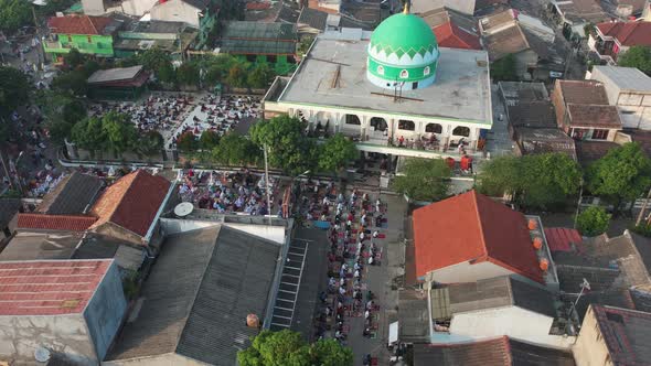 Aerial View of People offering prayers on the Eid morning at famous mosque Jama Masjid in Bekasi. alt