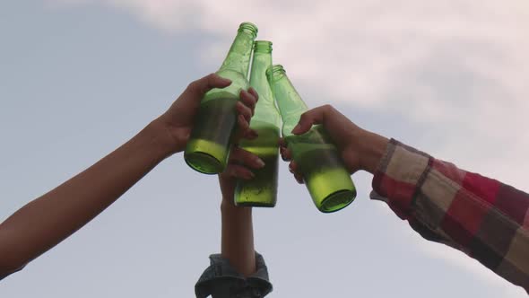 Group of a young Asian women happy friends camping in nature having fun together drinking beer.