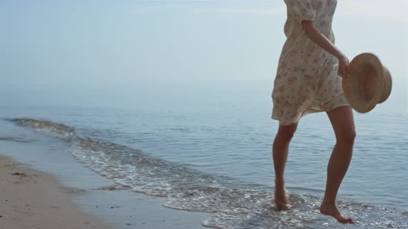 Slim Girl Running Ocean Water Holding Hat Summer Day alt