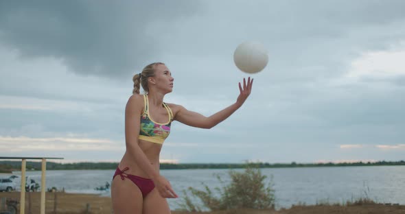 Serve in Beach Volleyball Match, Female Player Is Striking on Ball, Slow Motion Portrait on Open alt