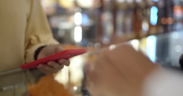 Young woman use smartwatch paying over contactless transactiona at cashier counter  alt
