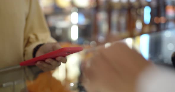 Young woman use smartwatch paying over contactless transactiona at cashier counter 