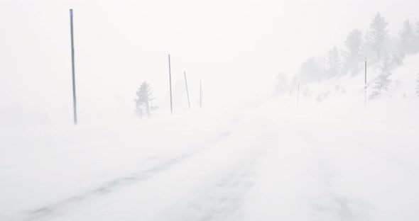 Car driving on road covered with snow