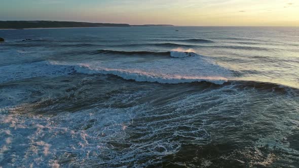 Aerial View on Big Ocean Waves and Sunset Sky