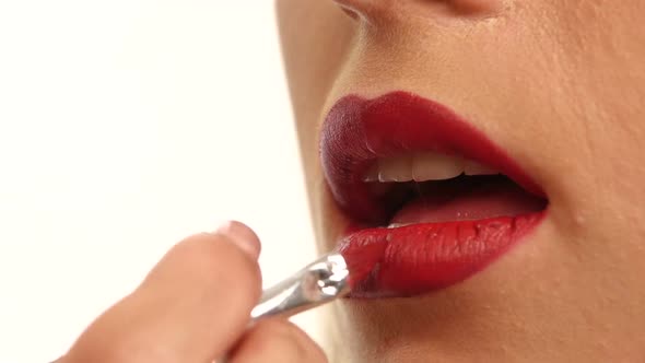 Woman's Lips with Bright Fashion Red Glossy Makeup. Close Up alt