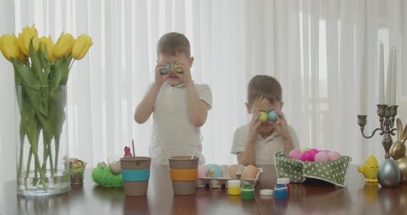 Two Brothers Play with Colored Eggs alt